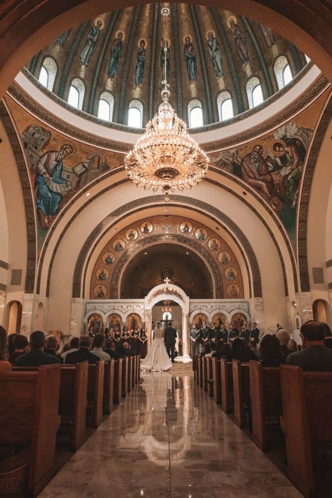 Traditional church wedding with bride and groom in front of the altar