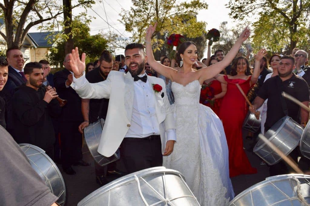 Red Gowns, An Ice Sculpture, And A Gravity Defying Wedding Cake