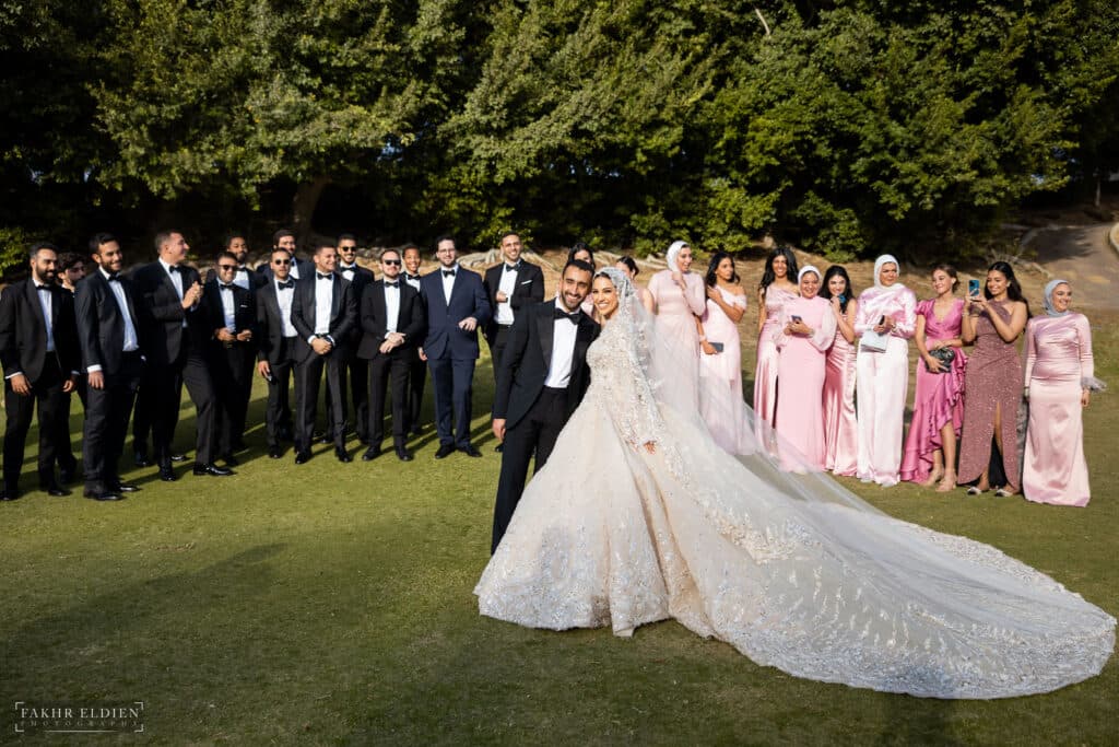 The happy bride and groom with their bridal party and loved ones.