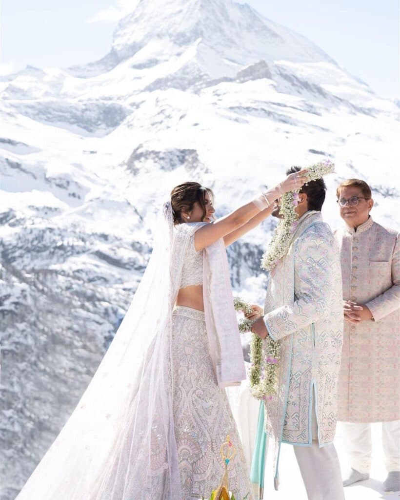 Beautiful Indian bride and groom having a traditional ceremony in the Swiss mountains