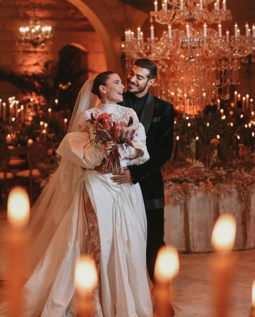 Bride and groom in candlelit reception.