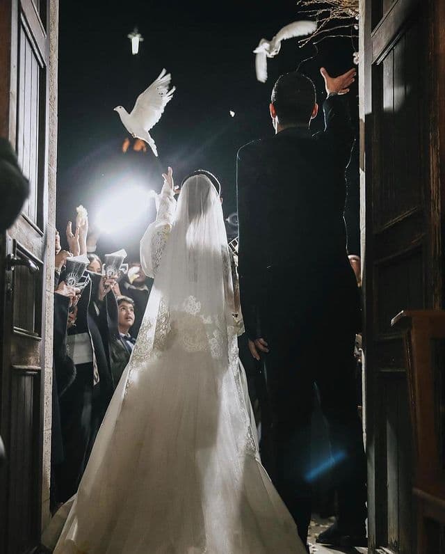 Bride and groom releasing doves. 