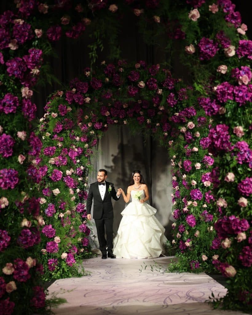 The overjoyed couple and stunning arc with pink florals