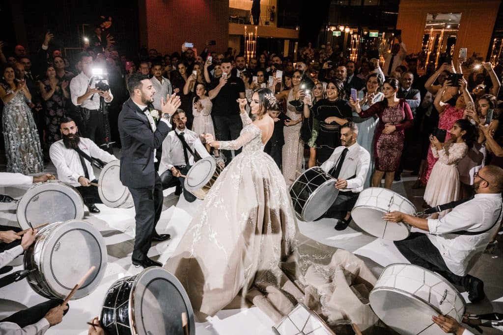 Lebanese bride and groom dancing in the center of a zaffe drum circle at their Sydney wedding