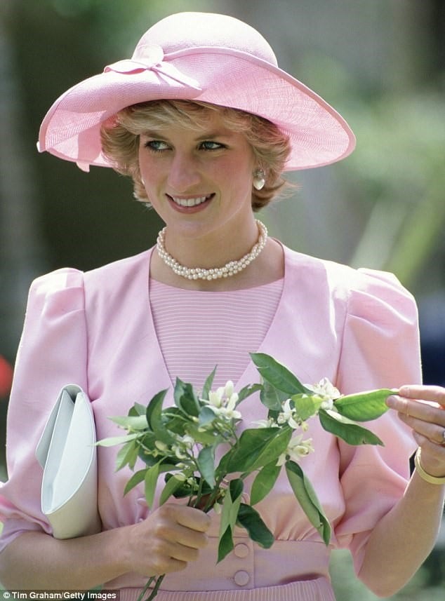 princess diana wearing pink and holding white flowers