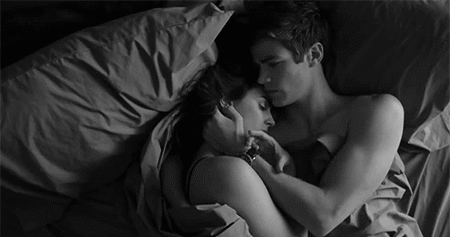 Couple cuddles in bed