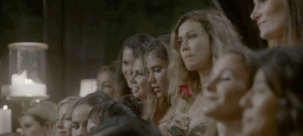 Sacha from The Bachelor eating a rose