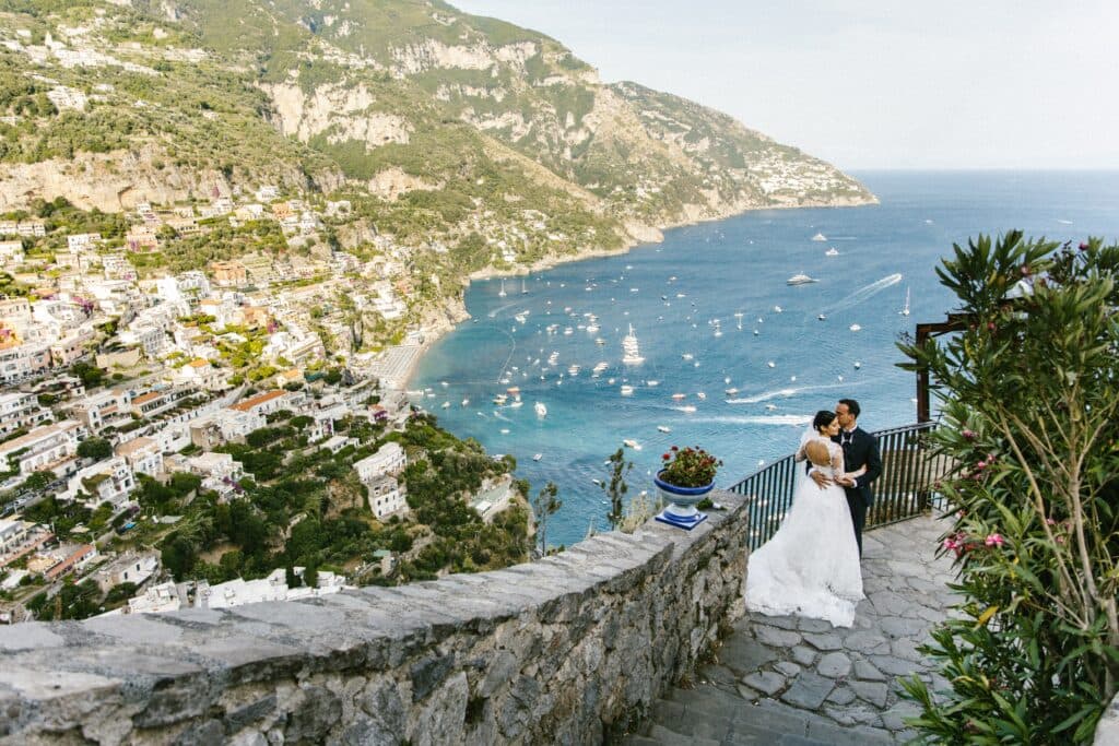 A couple on a coastal terrace at a destination wedding
