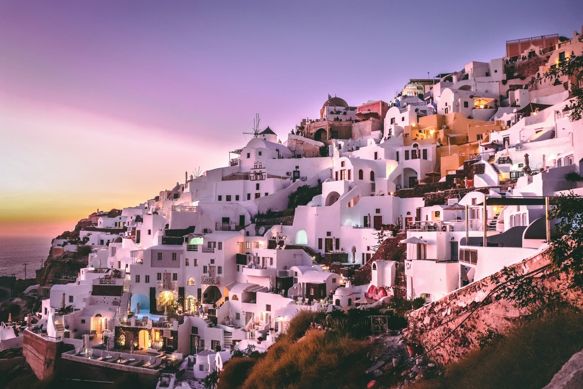 Whitewashed cliffside town at sunset