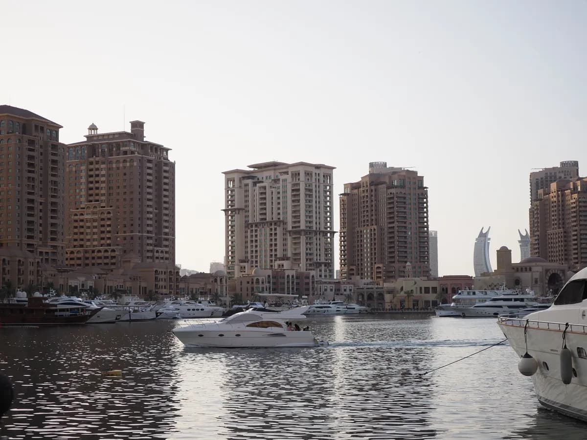 Yachts moored in a Doha marina at sunset