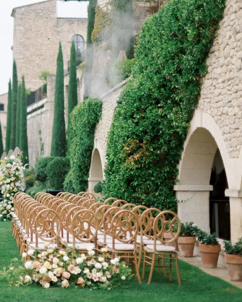 A garden wedding ceremony framed by cypress trees in the south of France