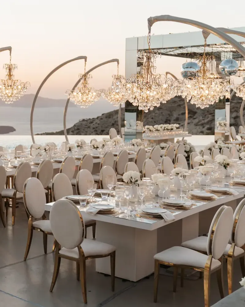 A wedding table on a whitewashed terrace above the Santorini caldera