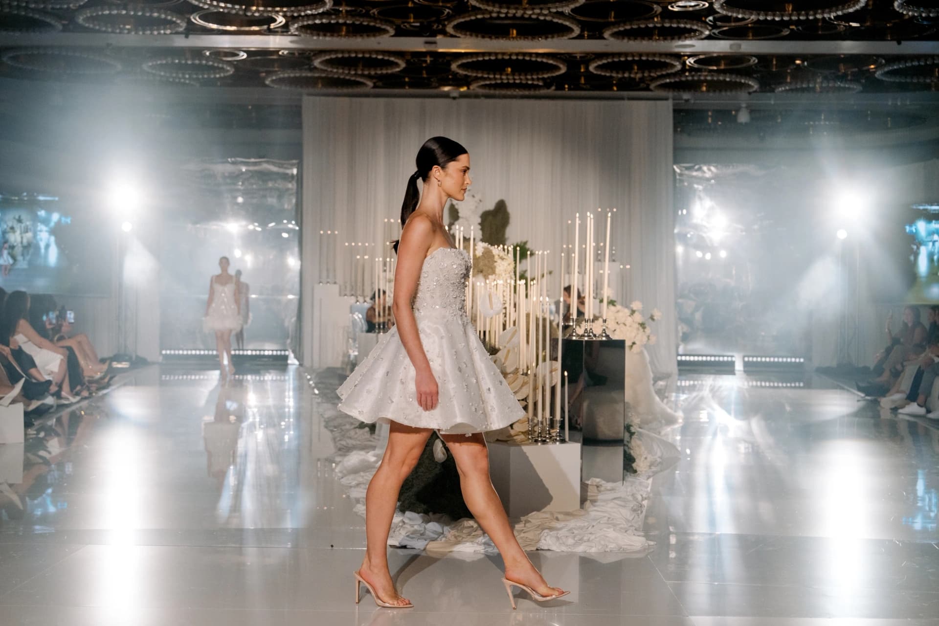 A model presenting bridal couture on the runway at Wedded World