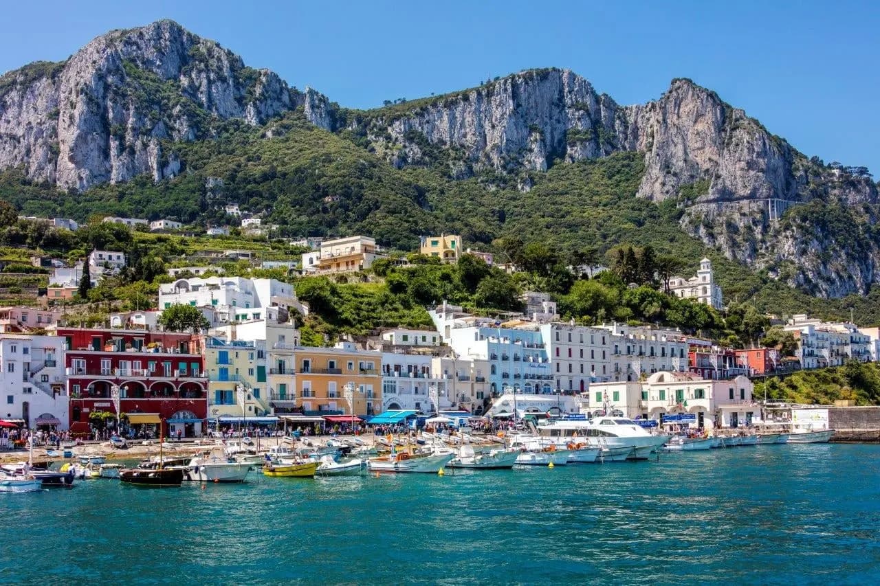 The harbour of Marina Grande on Capri below steep limestone mountains