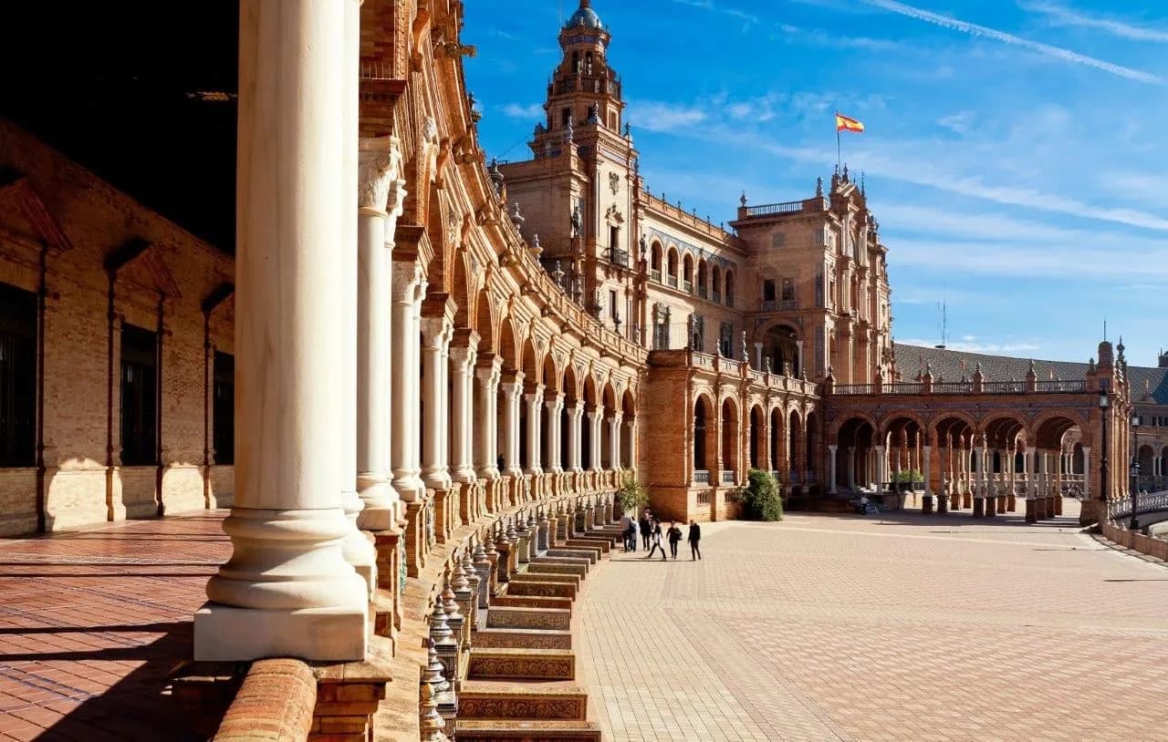 The curved brick colonnade and tower of Plaza de España in Seville