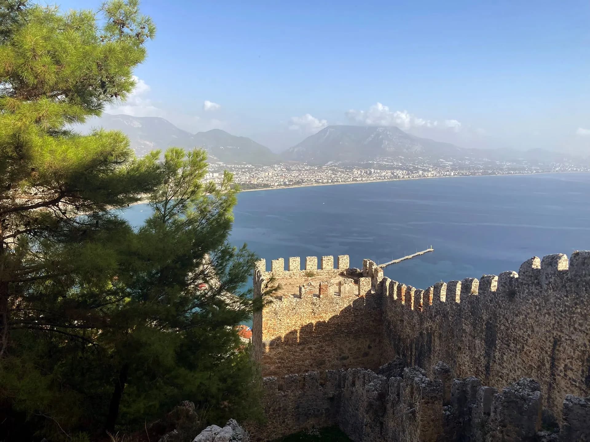 Crenellated castle walls looking along the coast at Alanya