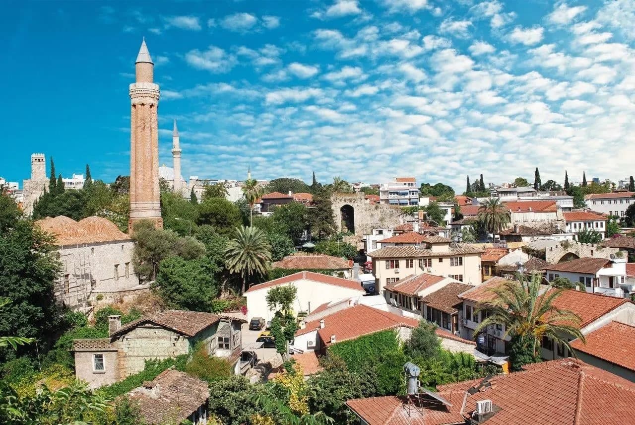 The fluted minaret above the red-roofed old town of Antalya