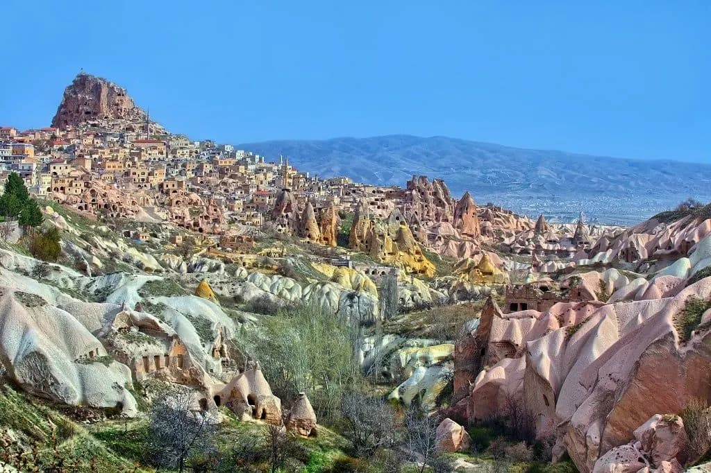 The rock castle of Uchisar above the pale valleys of Cappadocia