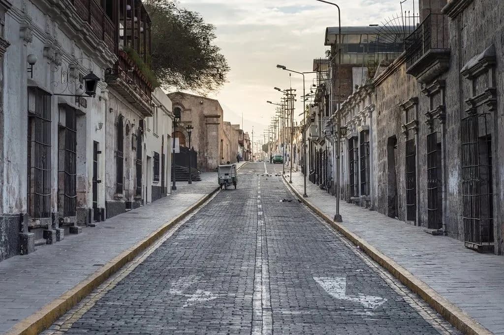 A quiet Arequipa street lined with white stone colonial houses