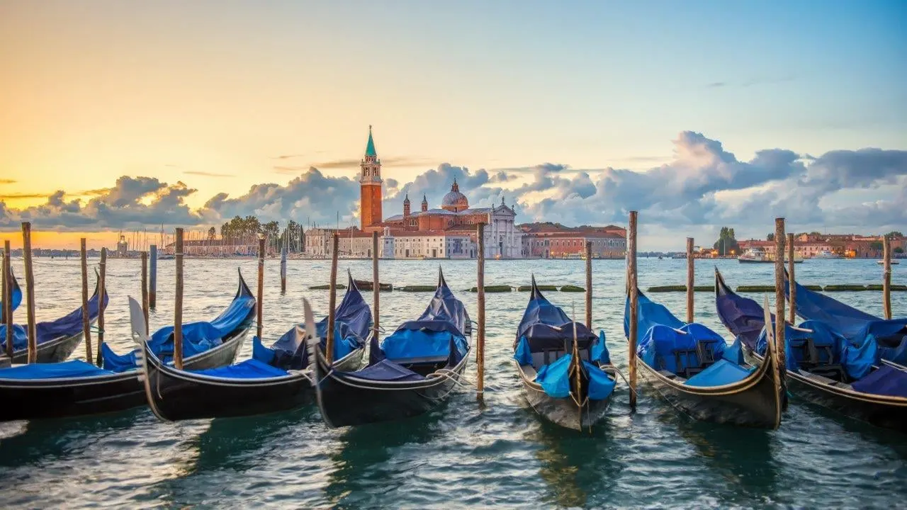 Gondolas moored at sunrise, looking across the water to San Giorgio Maggiore