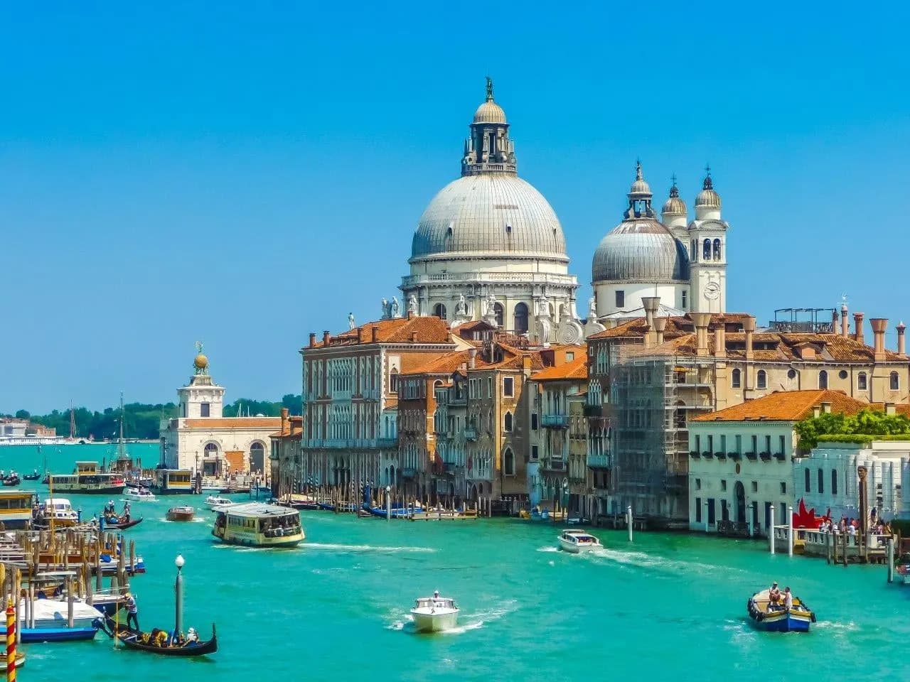 Boats on the Grand Canal in Venice below the domes of Santa Maria della Salute