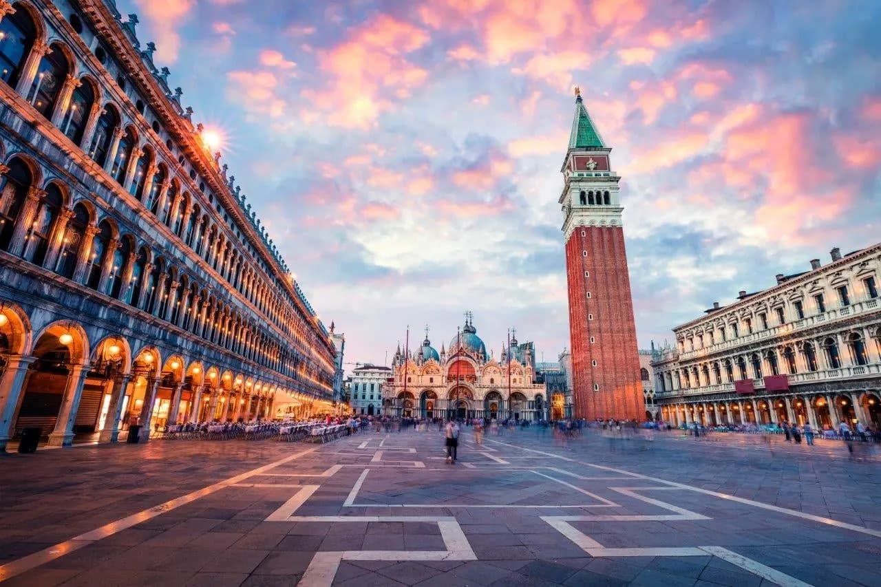 St Mark's Square in Venice at dusk, with the basilica and bell tower