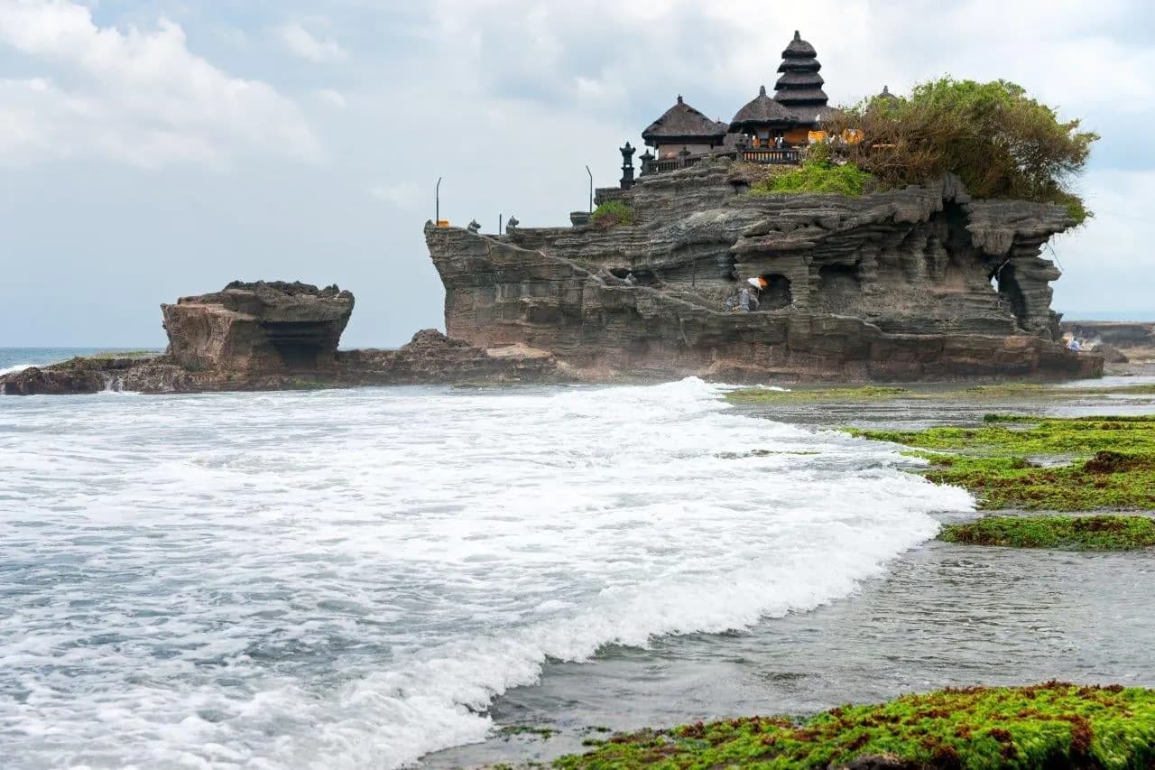 Tanah Lot temple on its rock above the breaking surf