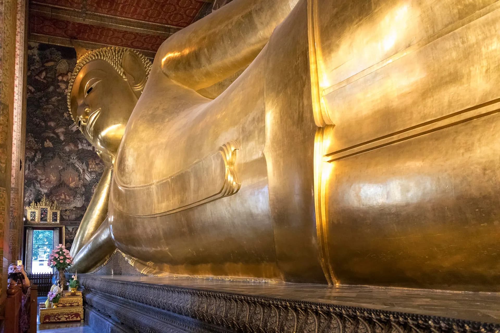 The golden reclining Buddha stretching along its hall at Wat Pho