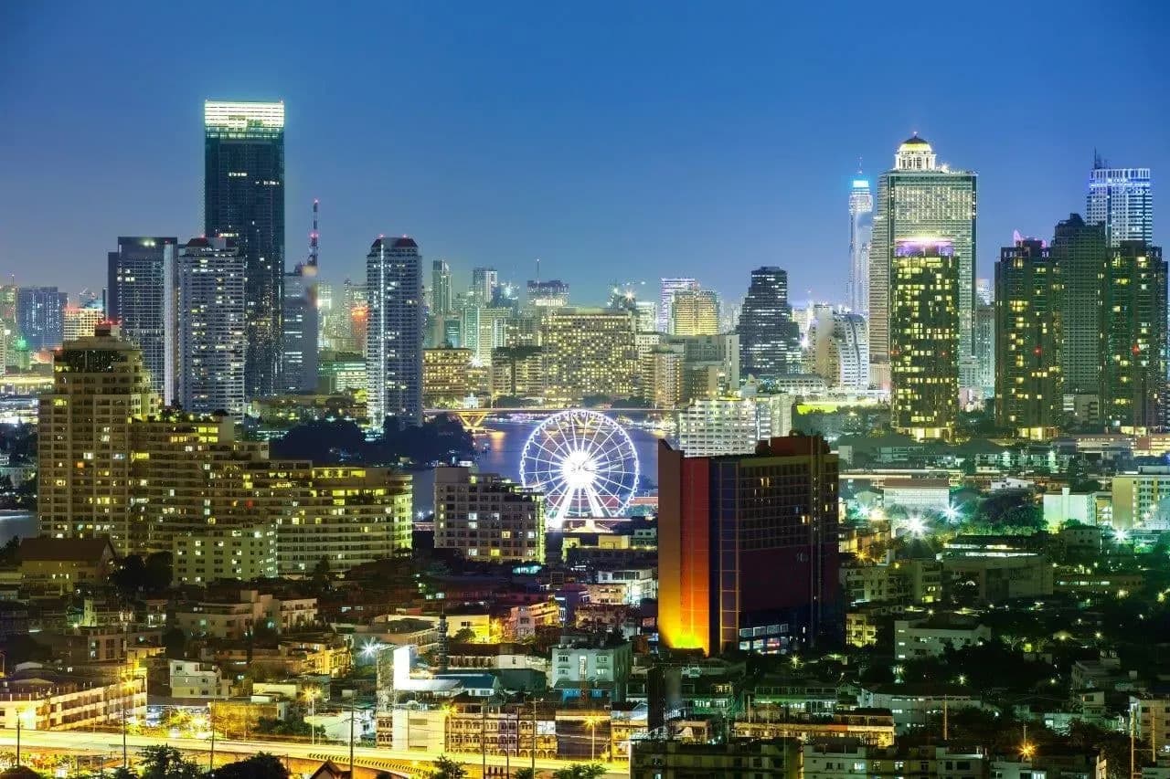 Bangkok's towers and a lit Ferris wheel at night