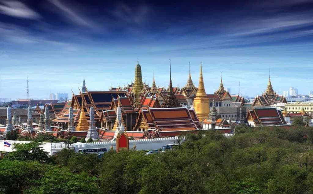 The spires of the Grand Palace rising above the trees of old Bangkok