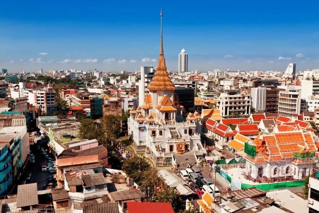 A gilded temple spire above the rooftops of central Bangkok