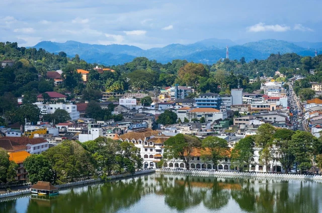 Kandy town and its lake below a line of blue hills