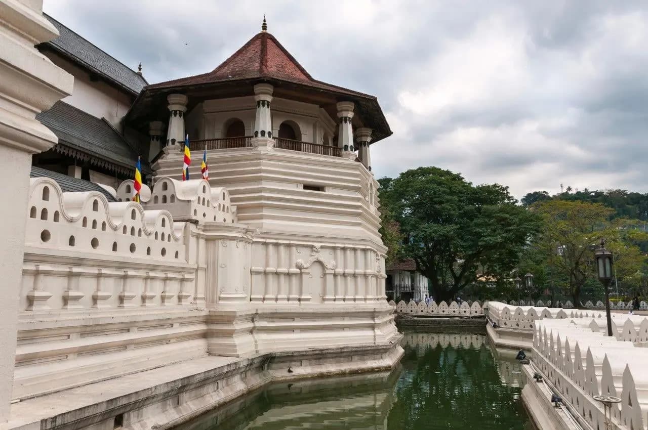 The white octagonal pavilion and moat of the Temple of the Tooth in Kandy