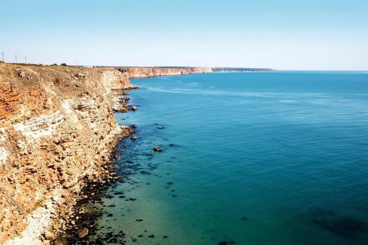 Golden cliffs falling into the turquoise Black Sea