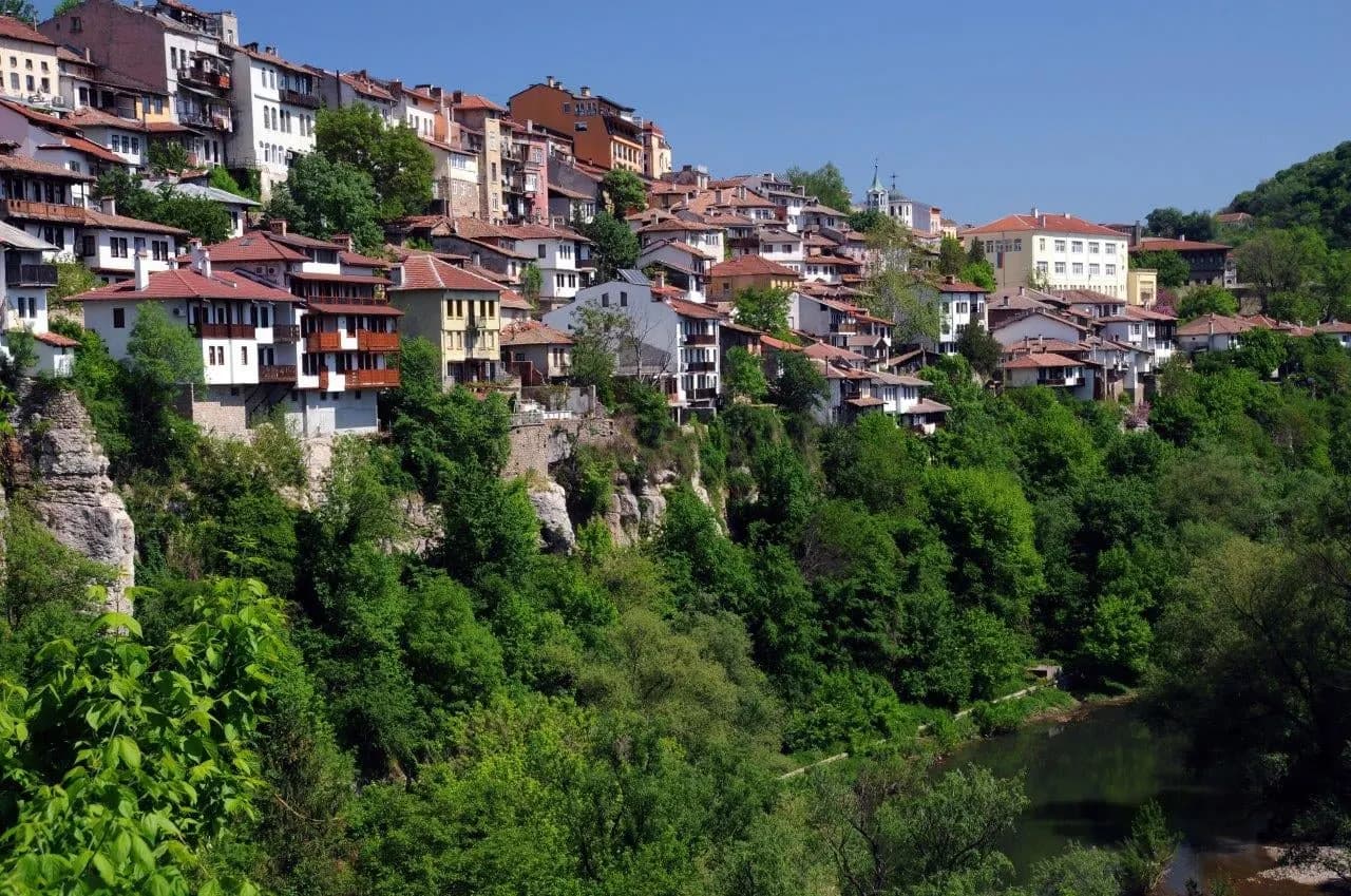 Veliko Tarnovo houses climbing the cliffs above a wooded gorge