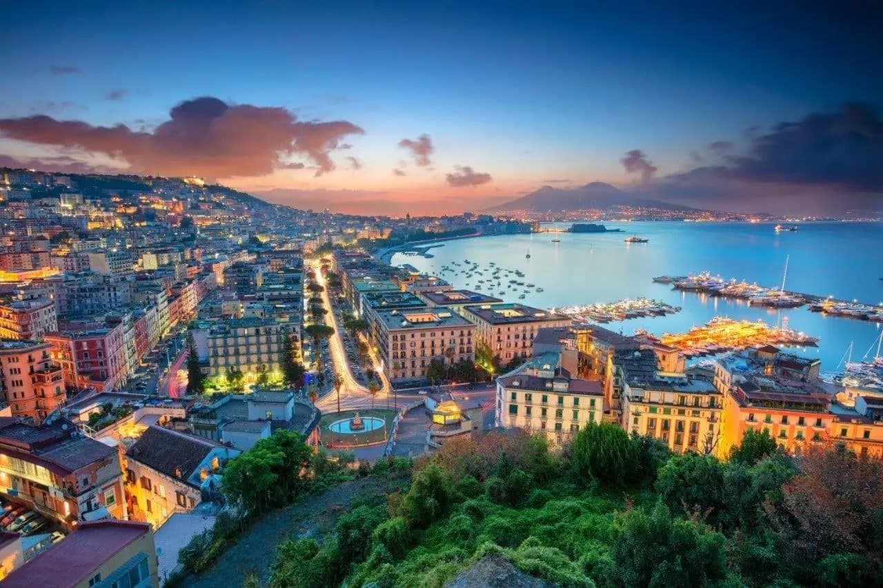 The lights of Naples along the bay at dusk