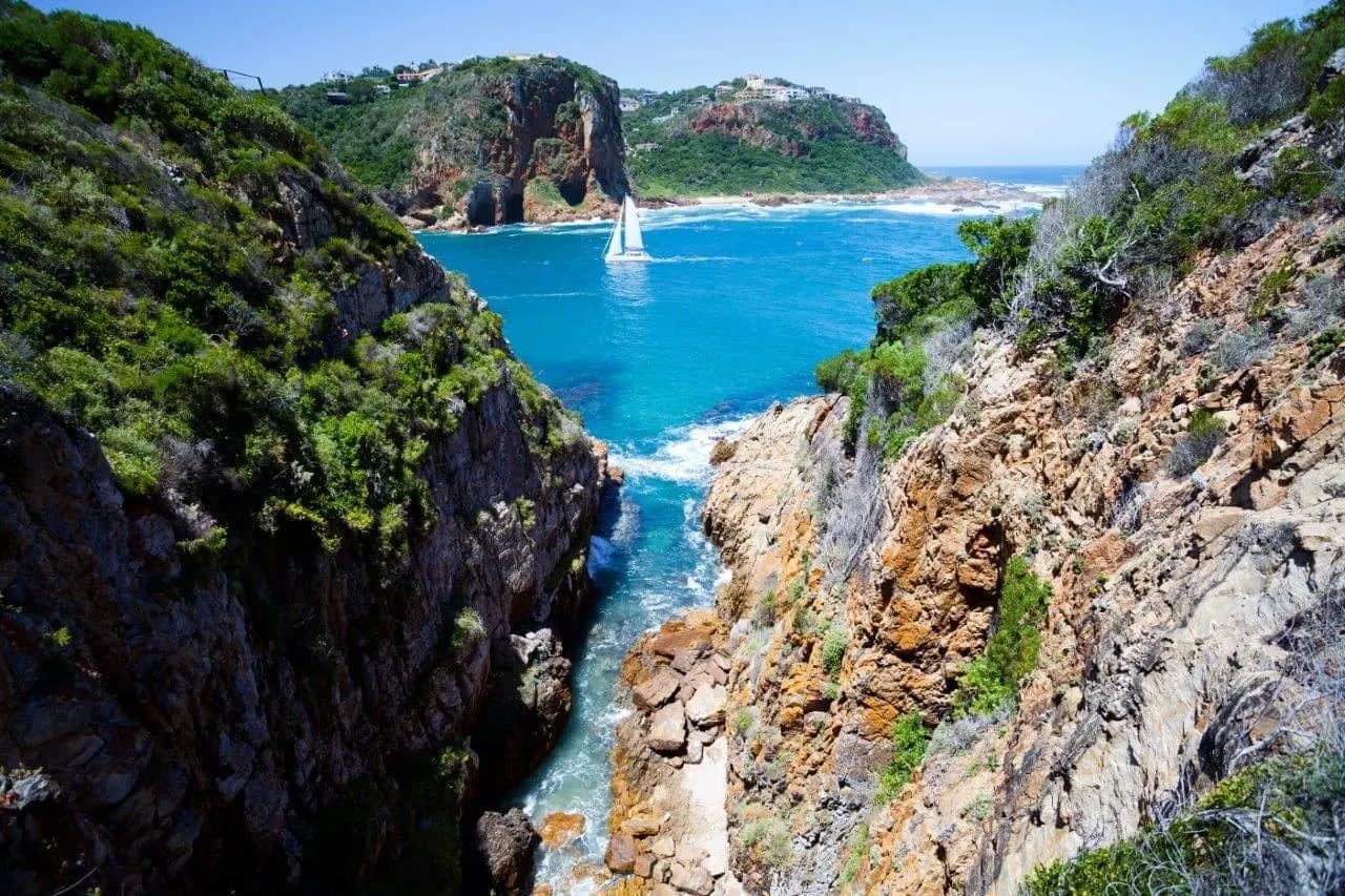The sandstone cliffs of the Knysna Heads above turquoise water