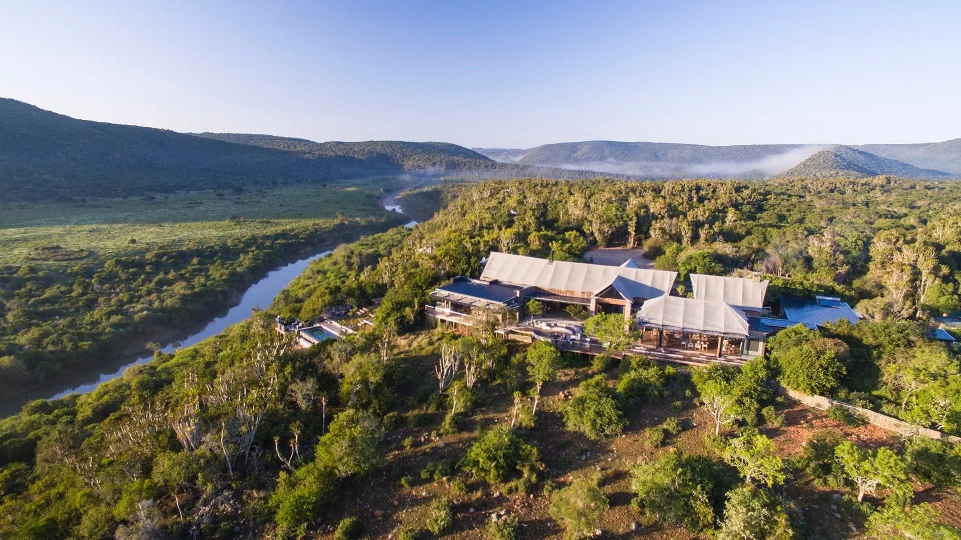 A safari lodge on a ridge above a winding river valley in the Eastern Cape