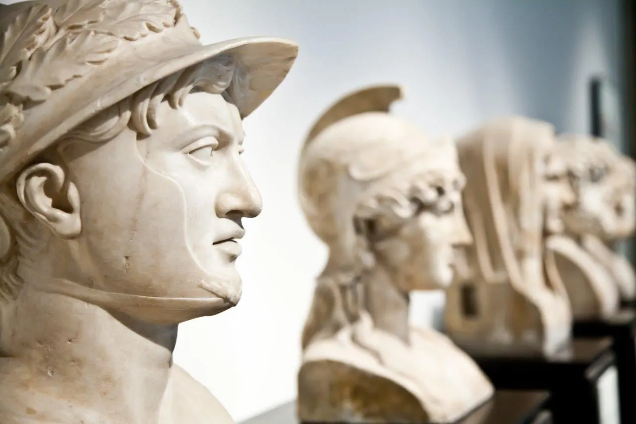 Classical marble busts lined up in a museum gallery