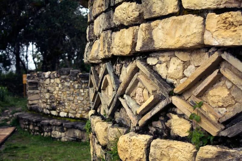 Diamond-shaped stone frieze on a curved wall at Kuélap