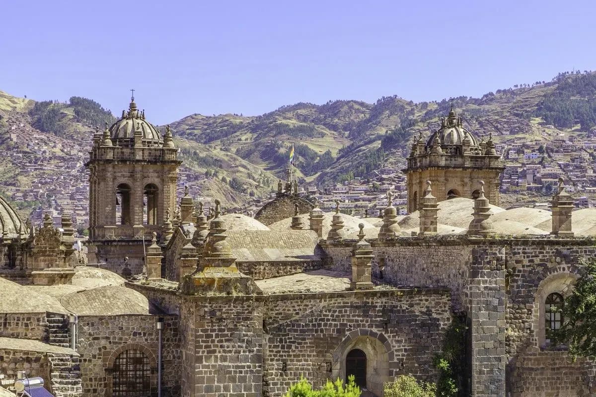 The domes and bell towers of Cusco's churches against the hills