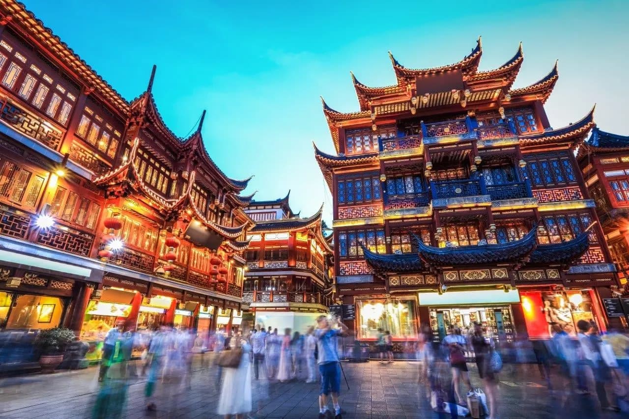 Lantern-lit traditional buildings in Shanghai's old town at dusk