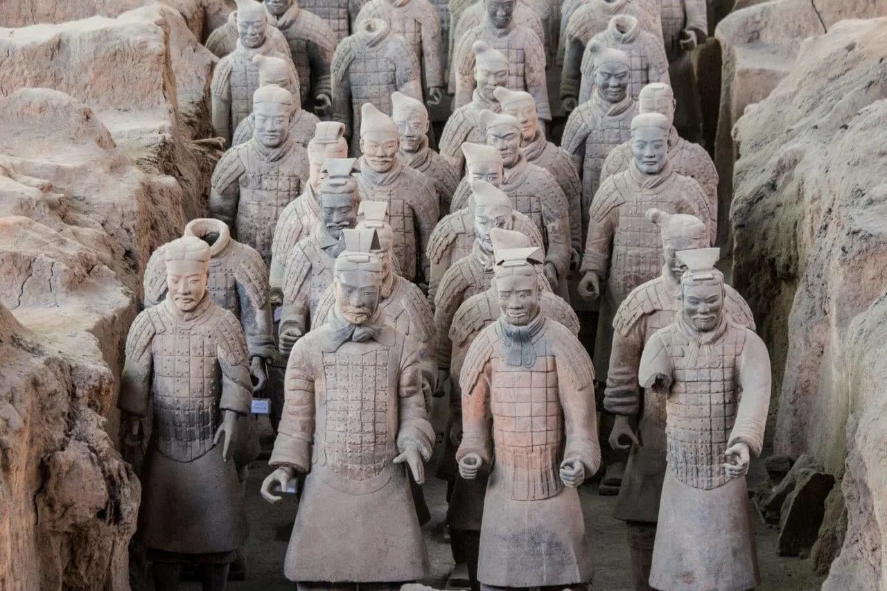 Ranks of terracotta warriors standing in their excavation pit at Xi'an