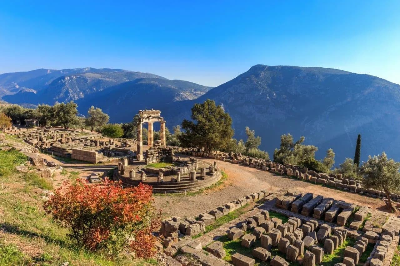 The round Tholos at the sanctuary of Athena Pronaia at Delphi, with mountains behind