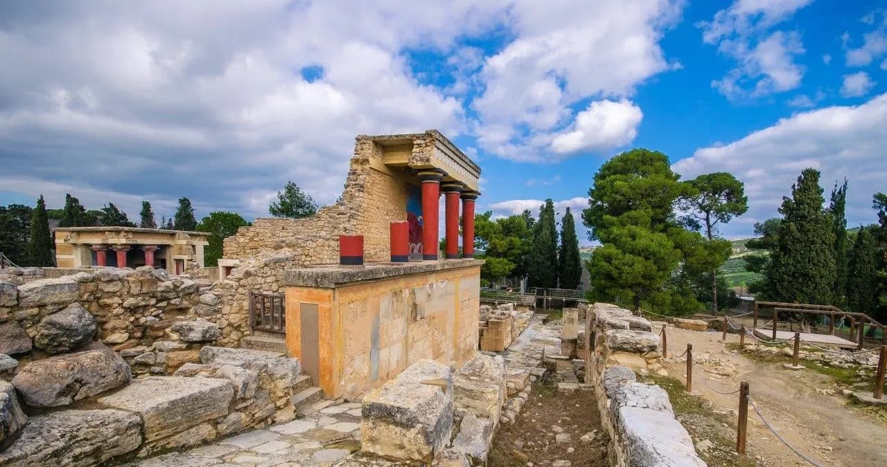 Red columns and restored walls at the Palace of Knossos