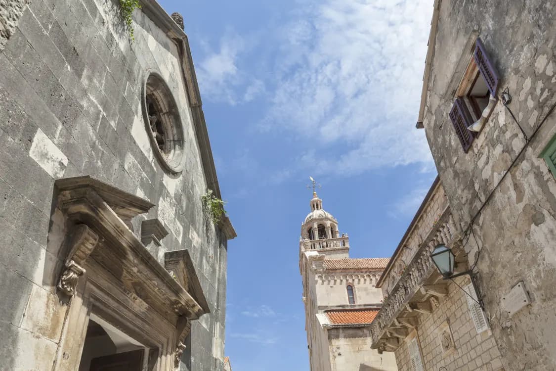 A narrow stone street in Korcula old town leading to the cathedral tower