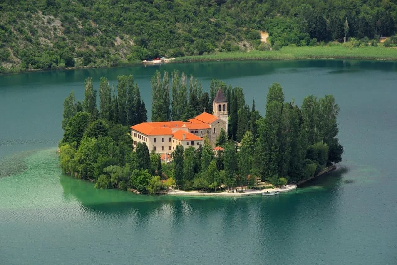 A monastery on a small wooded island in the Krka river