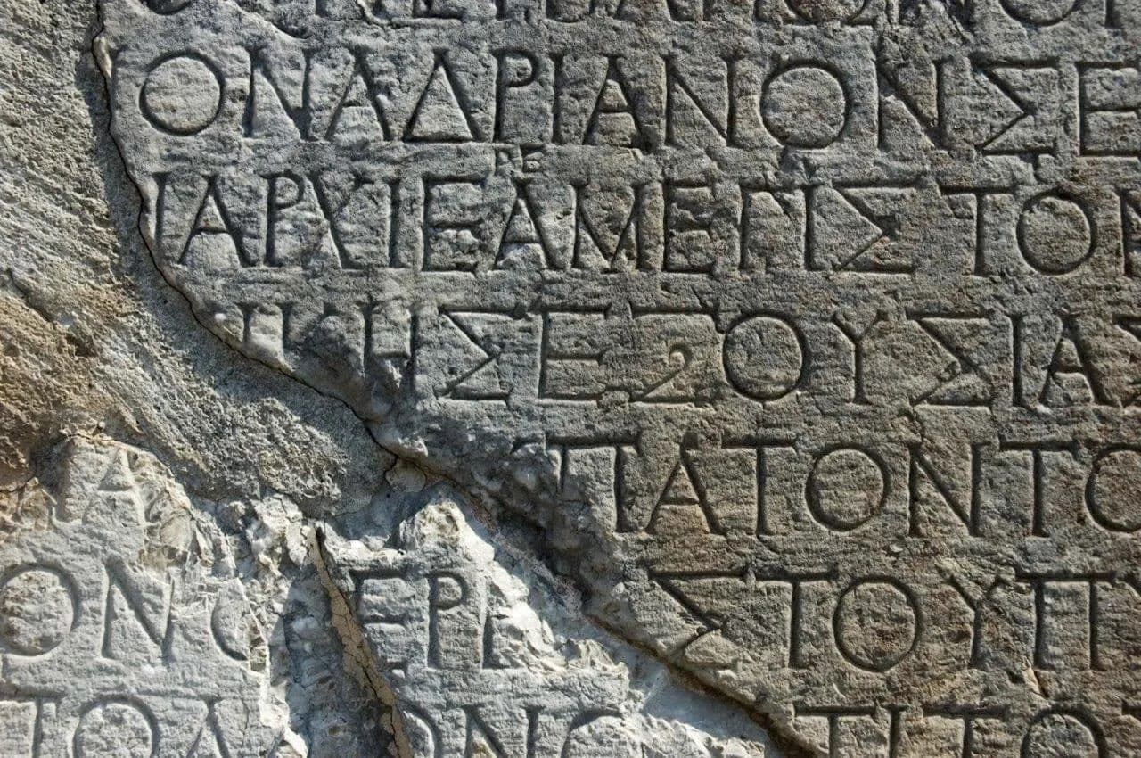 Ancient Greek letters carved into a block of stone