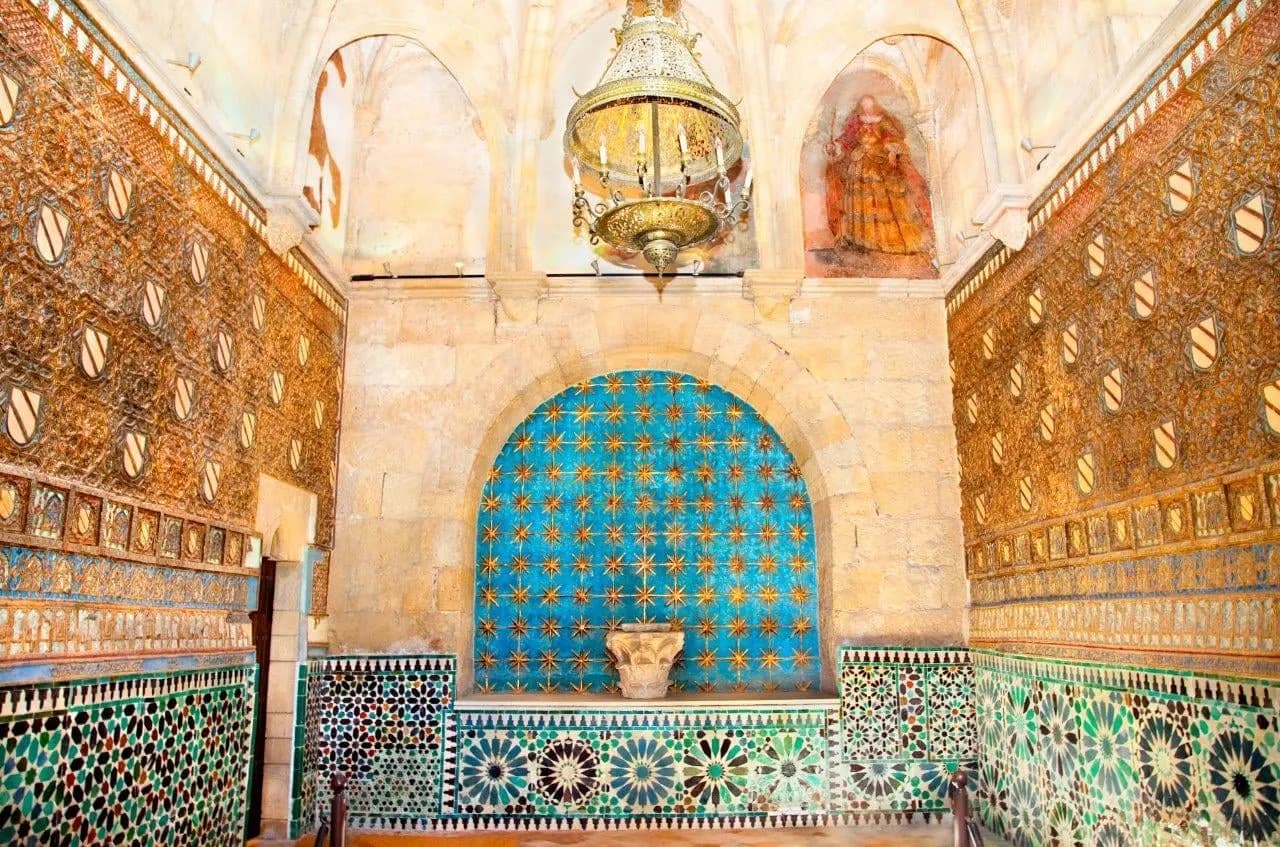 A Moorish alcove of patterned tiles beneath a brass lantern