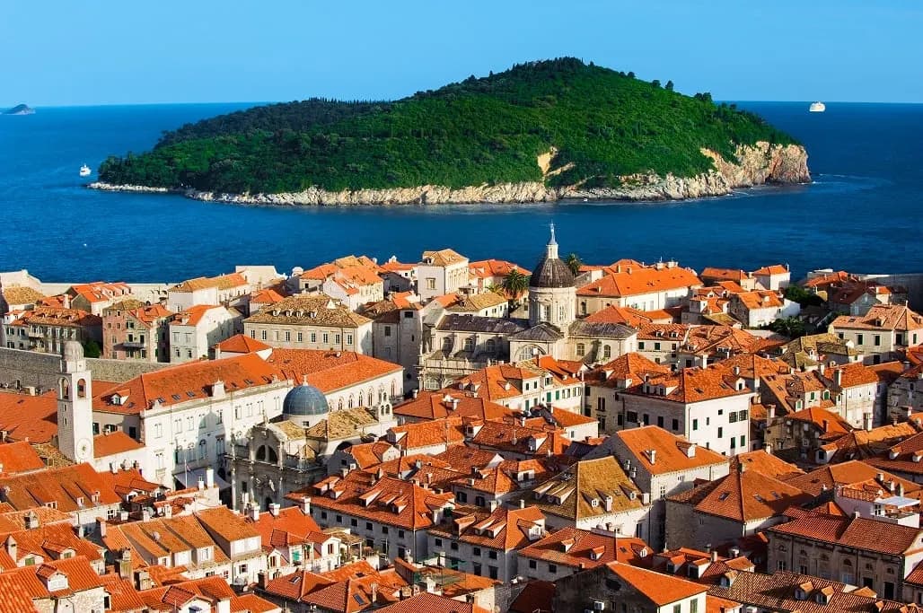 Terracotta rooftops of the old town with the green island of Lokrum offshore